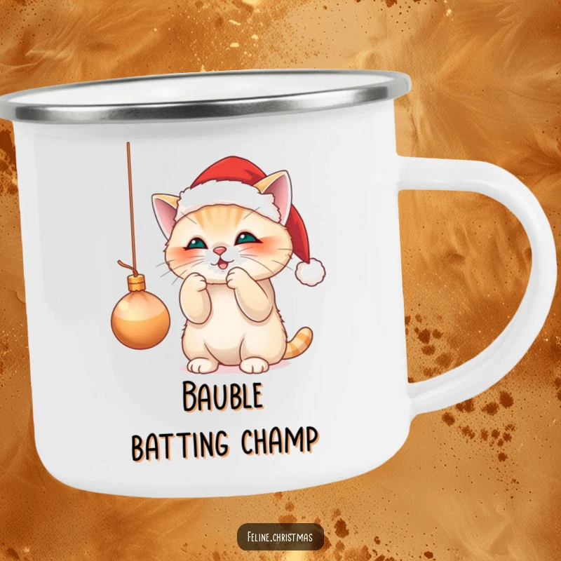 Funny camping mug with a cute cat in a Santa hat, playfully batting at a dangling Christmas ornament, for festive outdoor moments.