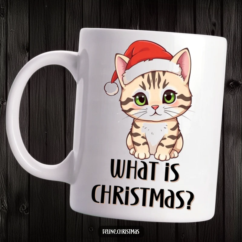 Funny tabby cat mug featuring a curious cat wearing a small Santa hat, looking up with wide, inquisitive eyes.