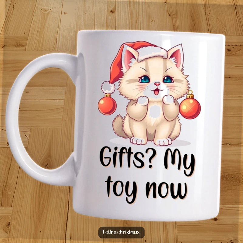 Funny cat mug: fluffy kitten in Santa hat playfully swats a Christmas ornament, exuding holiday joy and mischief.