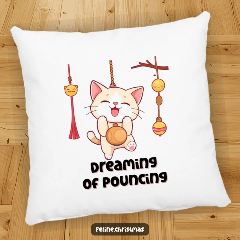 Funny pillow with a cat gleefully pouncing on a Christmas ornament, soft and humorous holiday home decor.