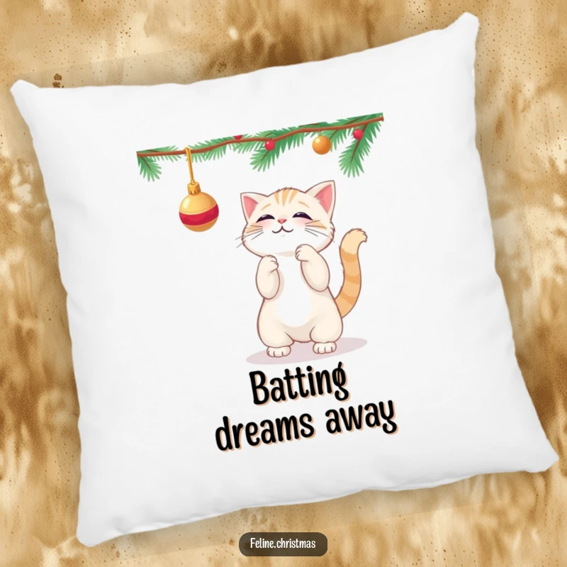 Funny kawaii cat playfully batting at a dangling Christmas ornament, on a soft and decorative pillow.