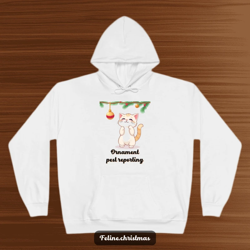 Funny kawaii cat playfully batting at a dangling Christmas ornament, printed on a soft, warm hoodie.