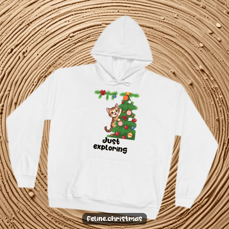 Funny tabby cat attempting to scale a Christmas tree with gleeful intent, printed on a soft and cozy hoodie.