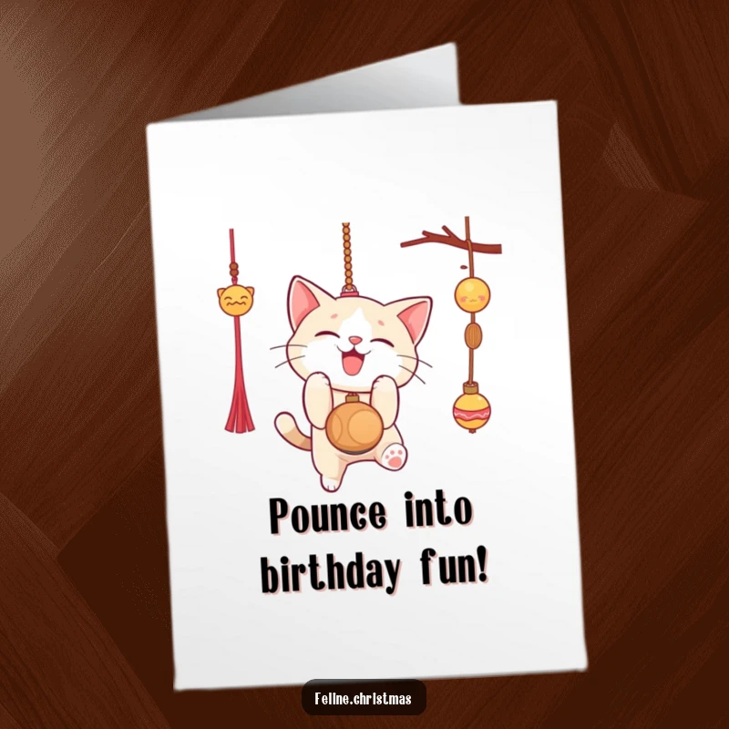 Funny Free Printable Birthday Card: Cat gleefully pouncing on a dangly ornament, full of playful mischief.
