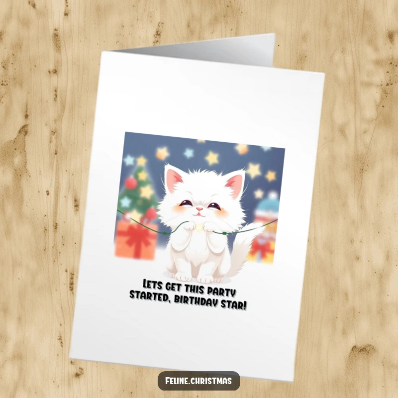 Funny Free Printable Christmas Cat Birthday Card of a fluffy white cat playfully batting at sparkling lights.