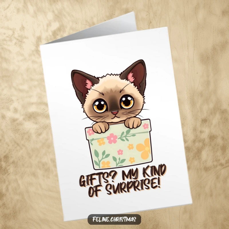 Funny Free Printable Birthday Card: A Siamese cat with wide eyes peeks out from inside a decorated gift box, ready for a surprise.