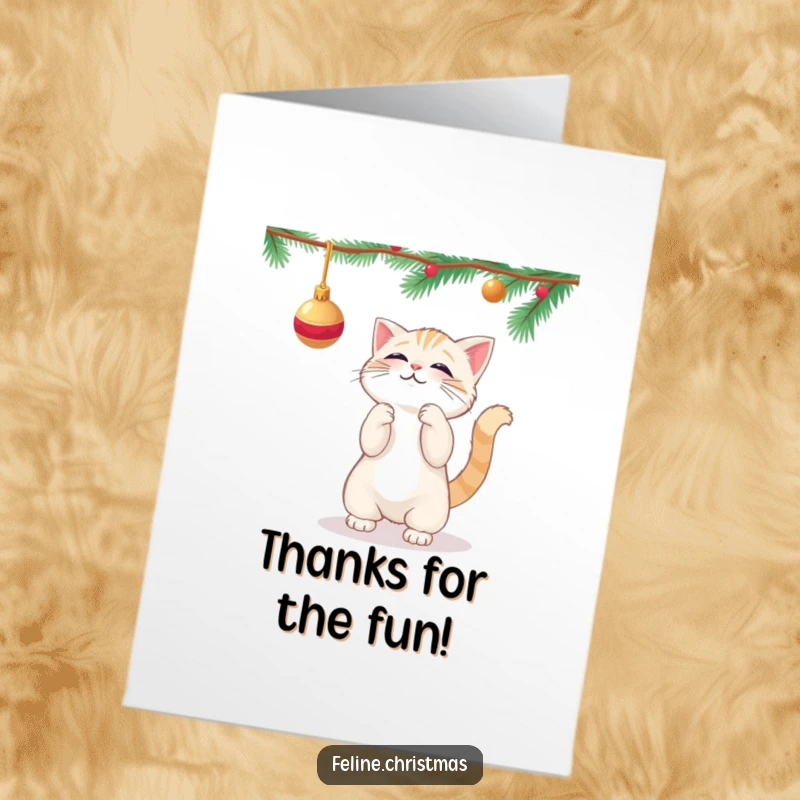 Funny free printable thank you card: Kawaii cat playfully batting at a dangling Christmas ornament, perfect for thanks.