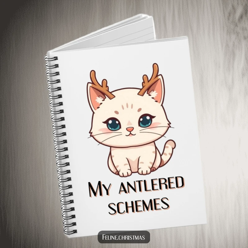 Funny cat character donning tiny reindeer antlers with a mischievous expression, on the cover of a lined notebook.