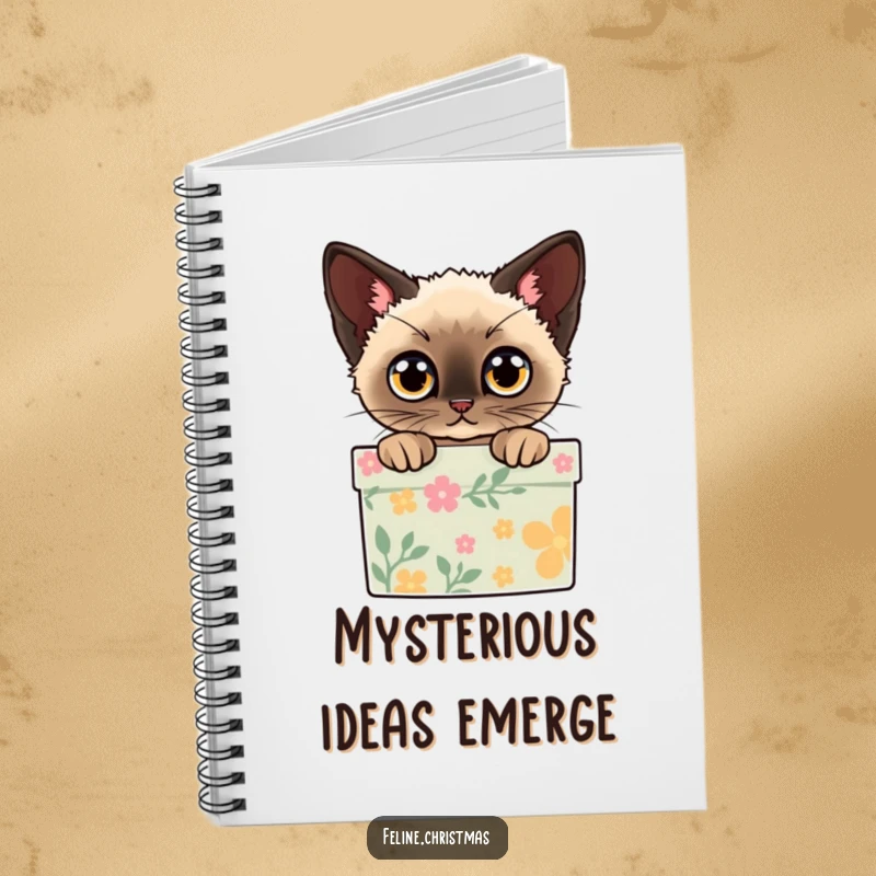 Funny notebook cover with a Siamese cat peeking out of a decorated gift box with wide eyes, ideal for holiday notes.