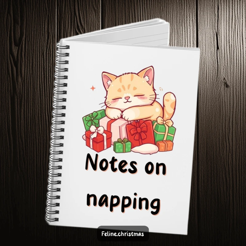 Funny cat notebook: cover depicts a content cat fast asleep on a pile of red and green Christmas presents.