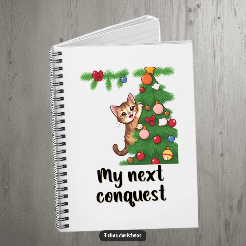 Funny tabby cat with playful energy attempting to climb a Christmas tree, on the cover of this humorous notebook.