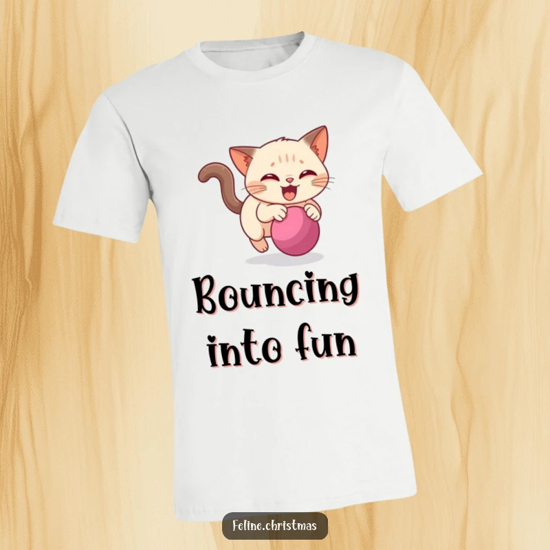Funny Siamese cat t-shirt showing a lively cat in pursuit of a rolling Christmas bauble, full of energy and festive delight.