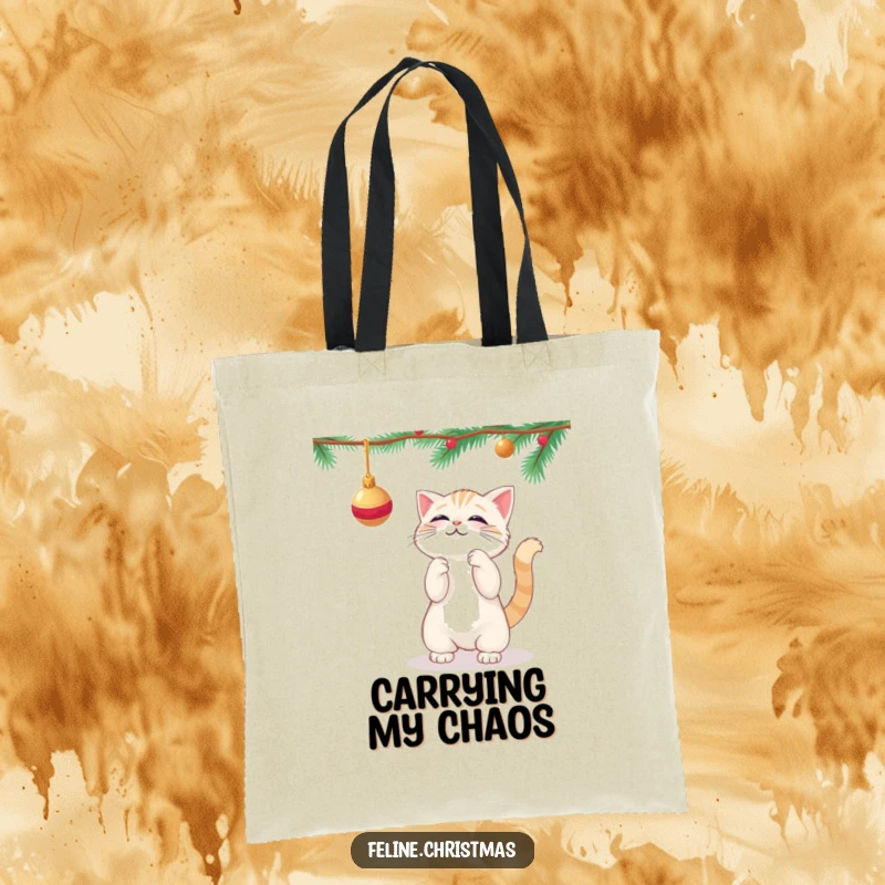 Funny kawaii cat playfully batting at a dangling Christmas ornament, on a durable and stylish tote bag.