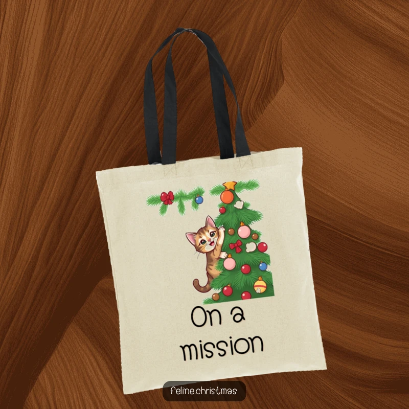 Funny tabby cat with playful intent scaling a Christmas tree, featured on a durable and chic tote bag.